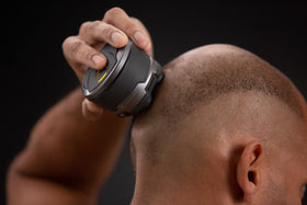 MicroTouch Titanium Head Shaver with hair capture chamber for easy cleanup.