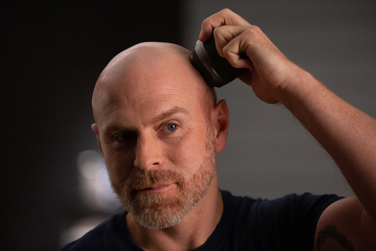 MicroTouch Titanium Head Shaver showing head-contouring action for safe, close shave.