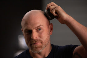MicroTouch Titanium Head Shaver showing head-contouring action for safe, close shave.