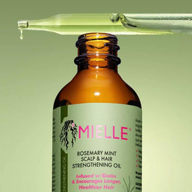 Mielle Organics Rosemary Mint packaging setup emphasizes premium hair care.