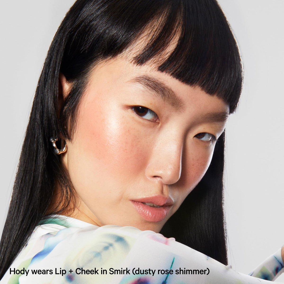 Milk Makeup Lip + Cheek Stick shown on lips with soft shimmer.