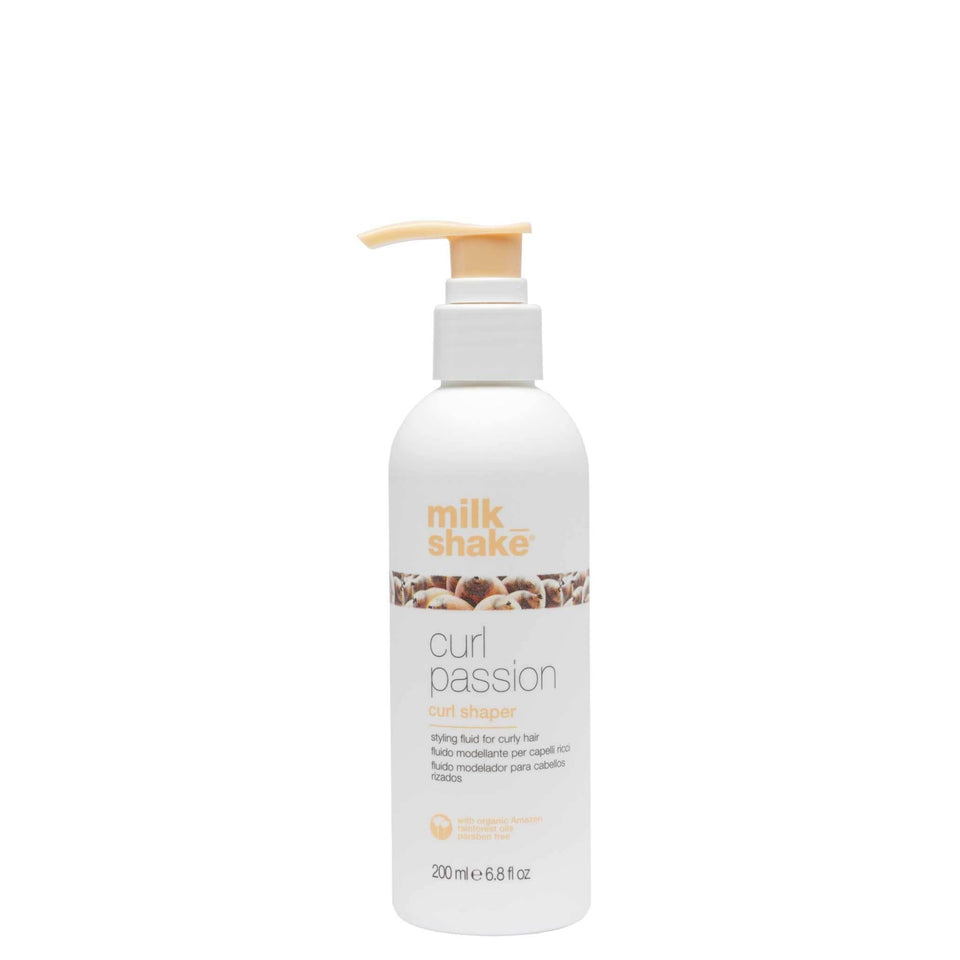 Milk Shake Curl Passion bottle with pump pouring to define curls.