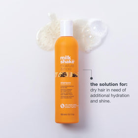 Milk Shake Moisture & More Shampoo being poured, forming creamy lather for hydration.