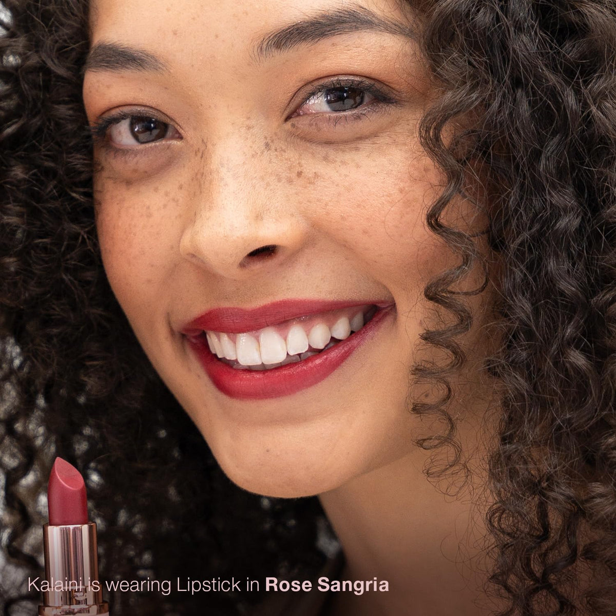 Rose Sangria lipstick application on lips demonstrates long-lasting satin finish.