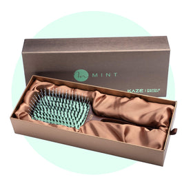 MINT durable paddle brush in use emphasizing long-lasting design.