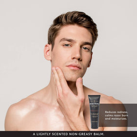 Applying Mistral balm on skin after shaving in a bright bathroom setting.