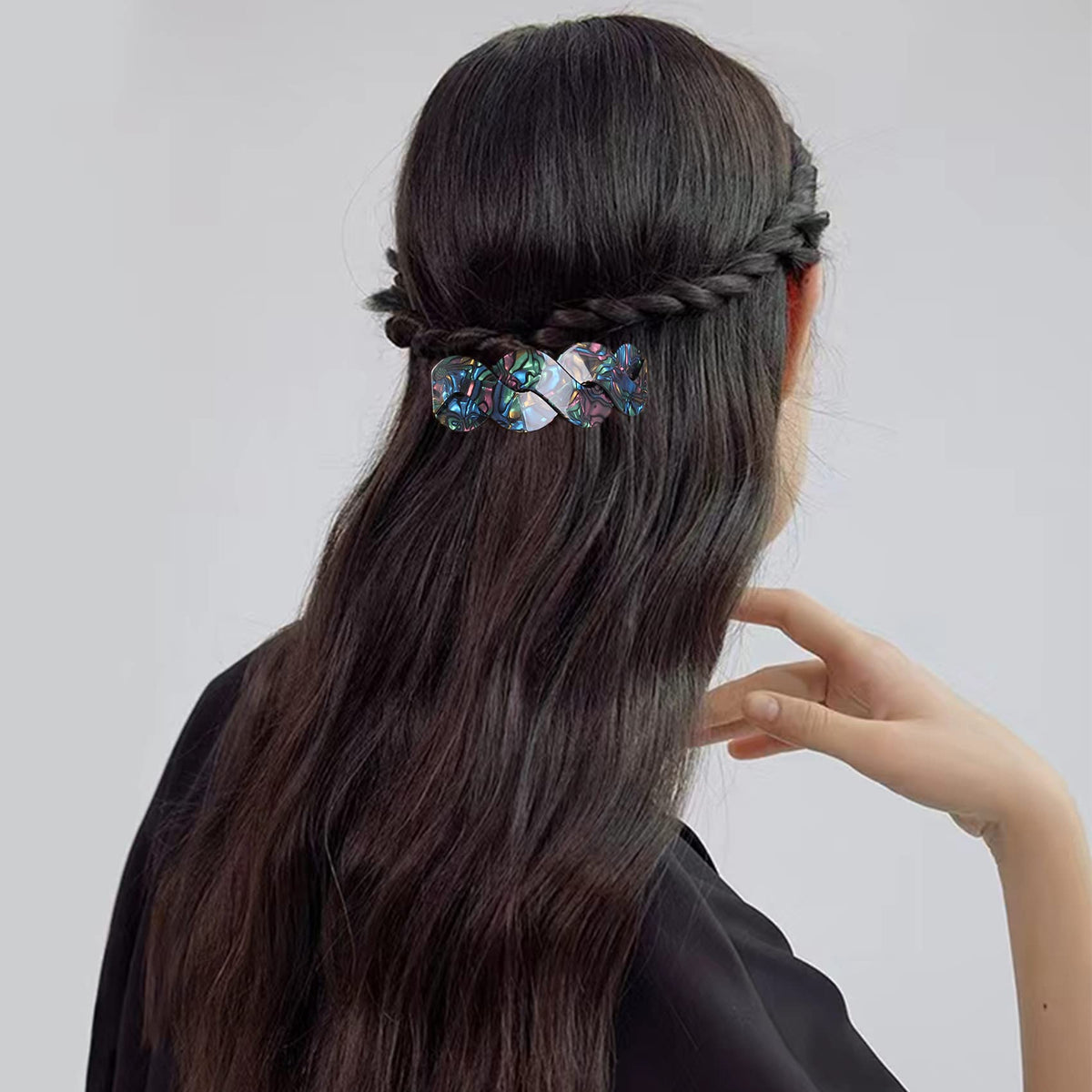 Mistofu barrette side view shows intricate tortoiseshell-abalone pattern while gripping long hair securely.