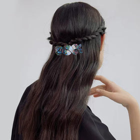 Mistofu barrette side view shows intricate tortoiseshell-abalone pattern while gripping long hair securely.