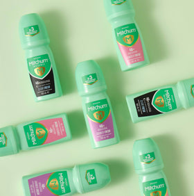 Mitchum Shower Fresh 100 ml bottle in hand for easy application.