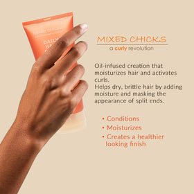 Mixed Chicks Daily Hair Dress application in hands for smooth strands