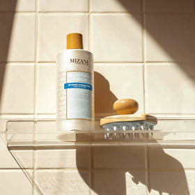 Curly hair textures appear healthy after Mizani cleansing.
