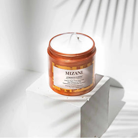 Packaging detail of Mizani Strength Fusion Night-Time Treatment highlighting anti-breakage tech