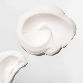 Creamy texture close-up of Mizani Strength Fusion Night-Time Treatment for hair
