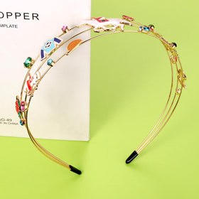 Mokkia derby headband with enamel horse detail for chic look.