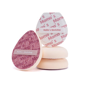 Momo's Workshop pink denim egg-shape sponge for fast full-face blending.