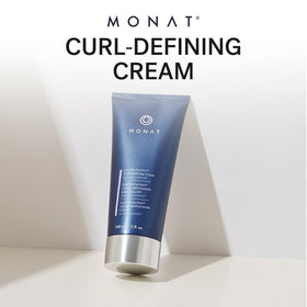 Texture close-up of MONAT Curl Perfection Cream showing creamy detangling slip.
