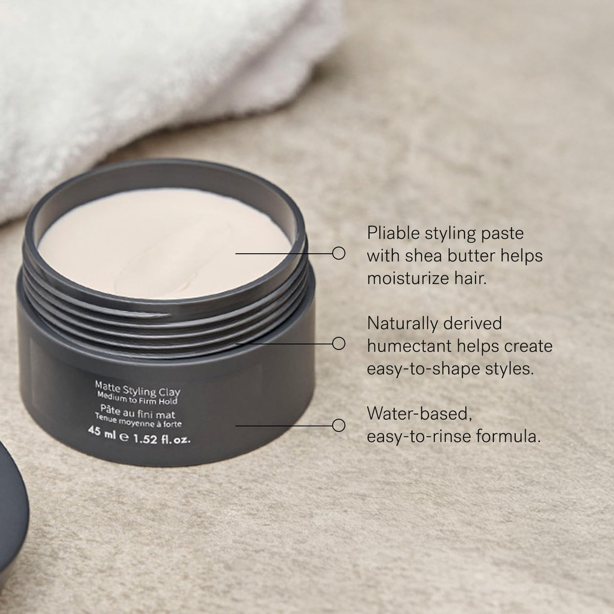 MONAT Matte Styling Clay hands applying product demonstrates pliable moldability for easy styling