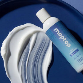 MopTop conditioner applied to wet curls for smoother detangling.