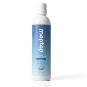 MopTop Daily Curly Hair Conditioner bottle showing silicone-free formula for frizz control.