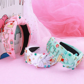 MOSOTECH headband features book and apple charms for educational flair.