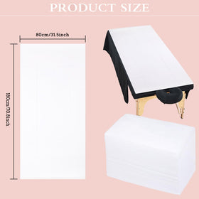 MRJ White bed sheet draped on a massage table, highlighting a quiet professional setup.