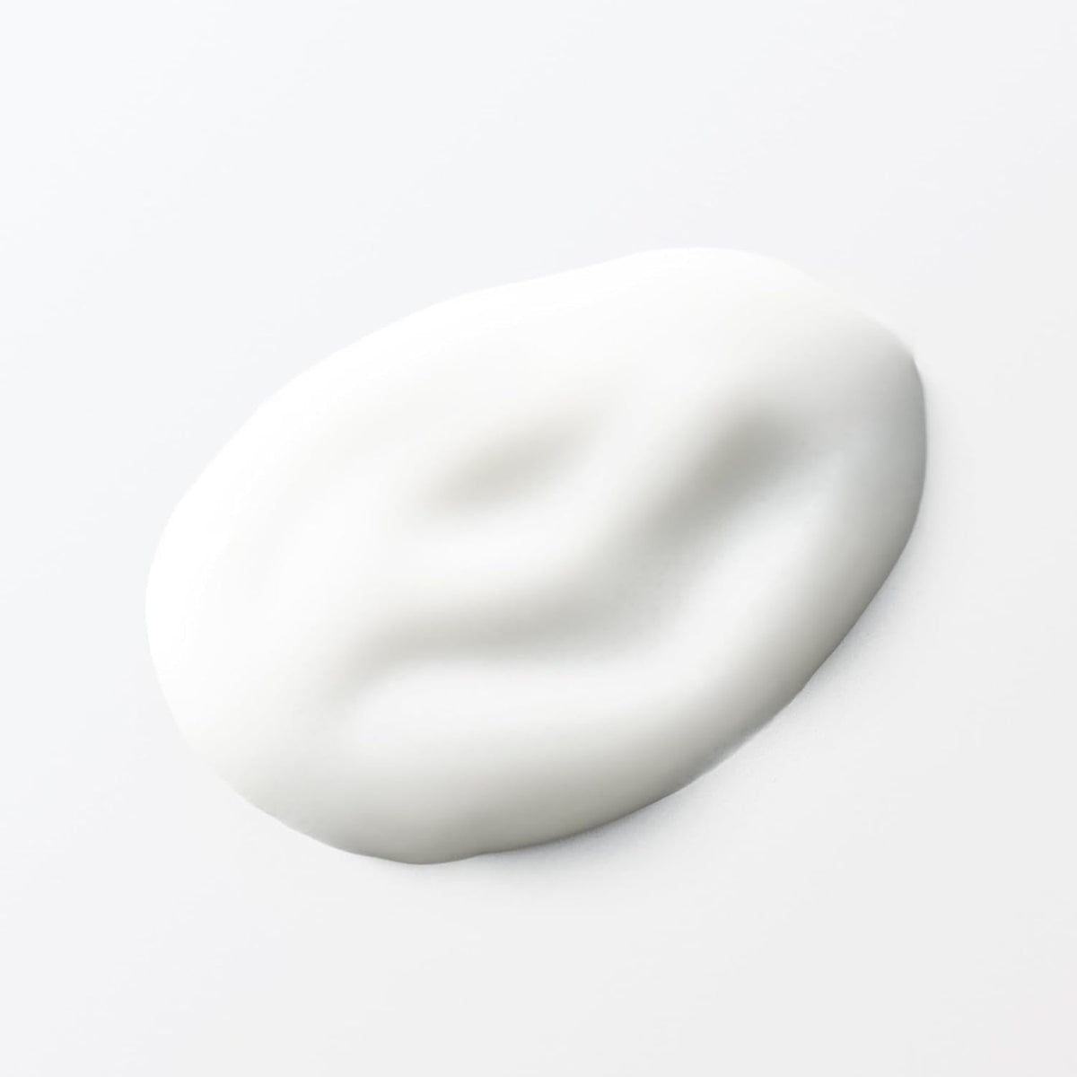 Hands applying MUJI lotion during daily skincare routine.