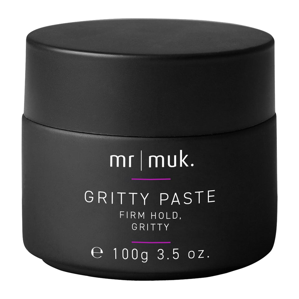 Mr MUK Strong Hold paste jar close-up, showcasing texture and firm hold for lasting style.