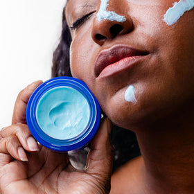 Nakery Night Shift bottle on bathroom shelf conveys simple nightly skincare ritual.