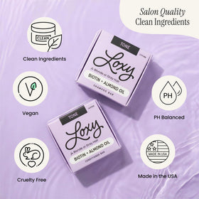 NATURÉL Loxy Purple Shampoo Bar held in hand for travel and gym use