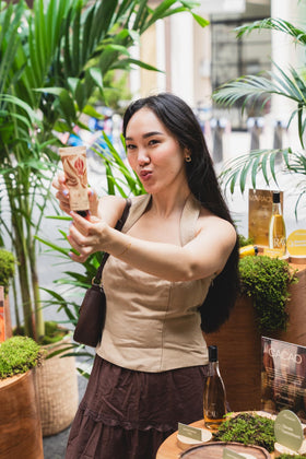 Natura Ekos Cacau hand cream being massaged onto skin.