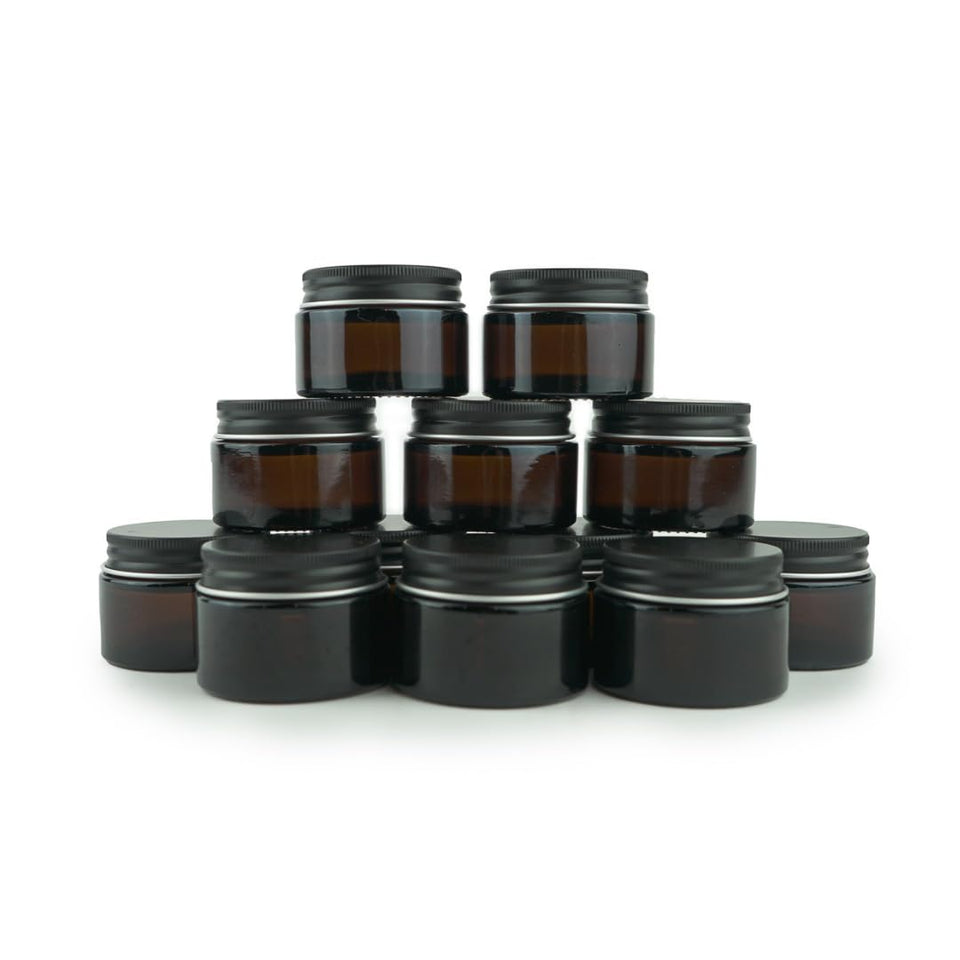 Nature Packaged amber jar with black lid, travel-friendly cosmetic container.