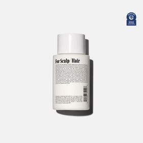 Nécessaire The Conditioner Mini product application shot shows detangling for smoother hair.