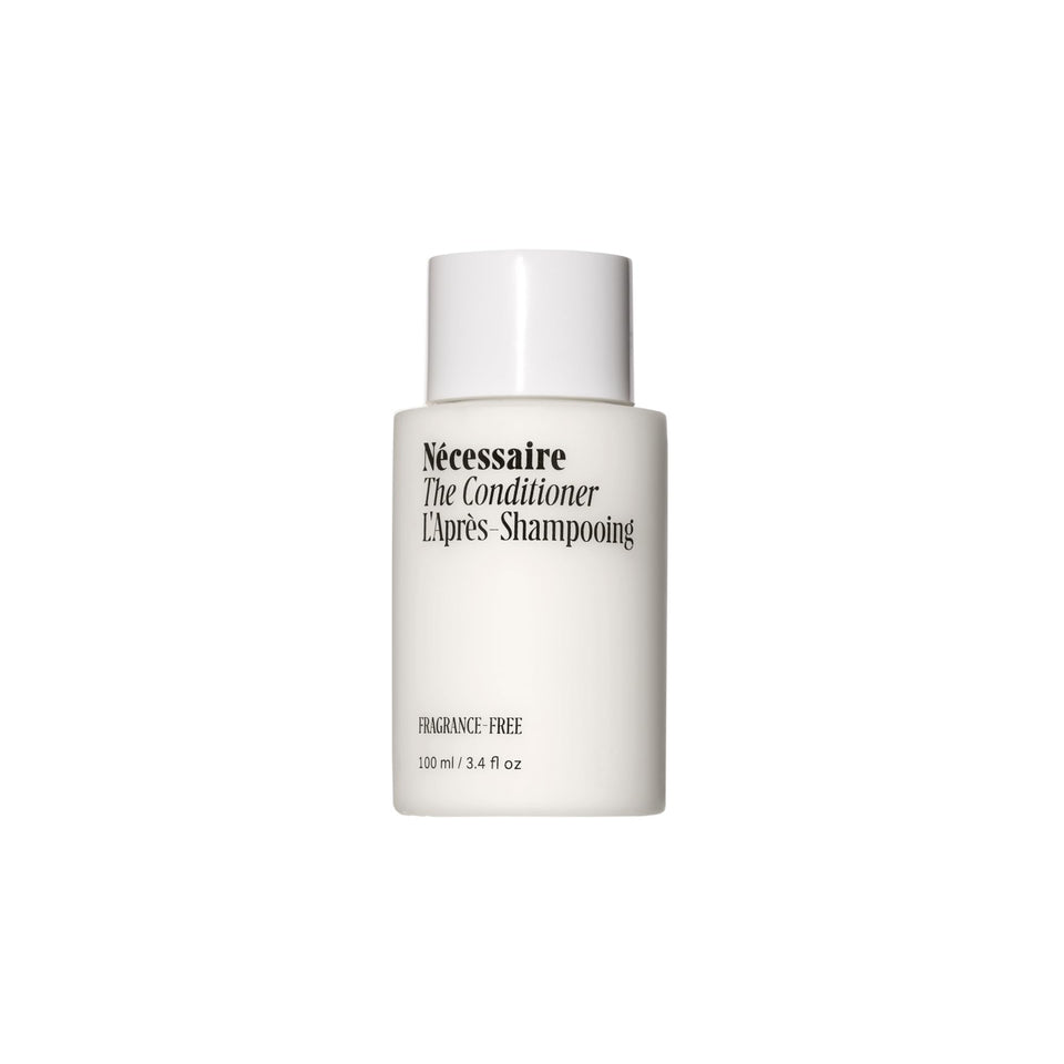 Nécessaire The Conditioner Mini bottle closeup highlights fragrance-free formula for sensitive scalps.