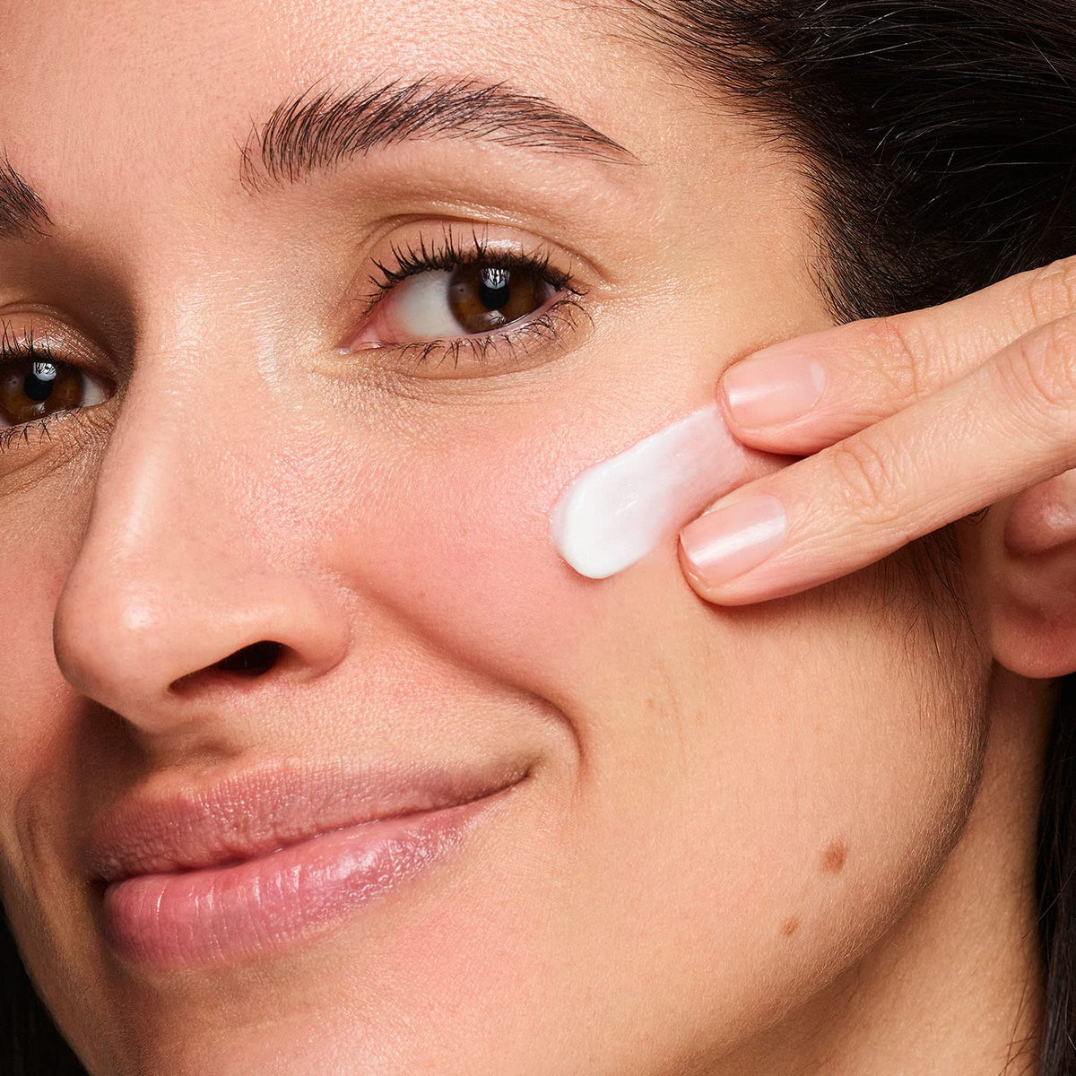 Applying NEOSTRATA cream to facial skin for daily moisture and comfort.