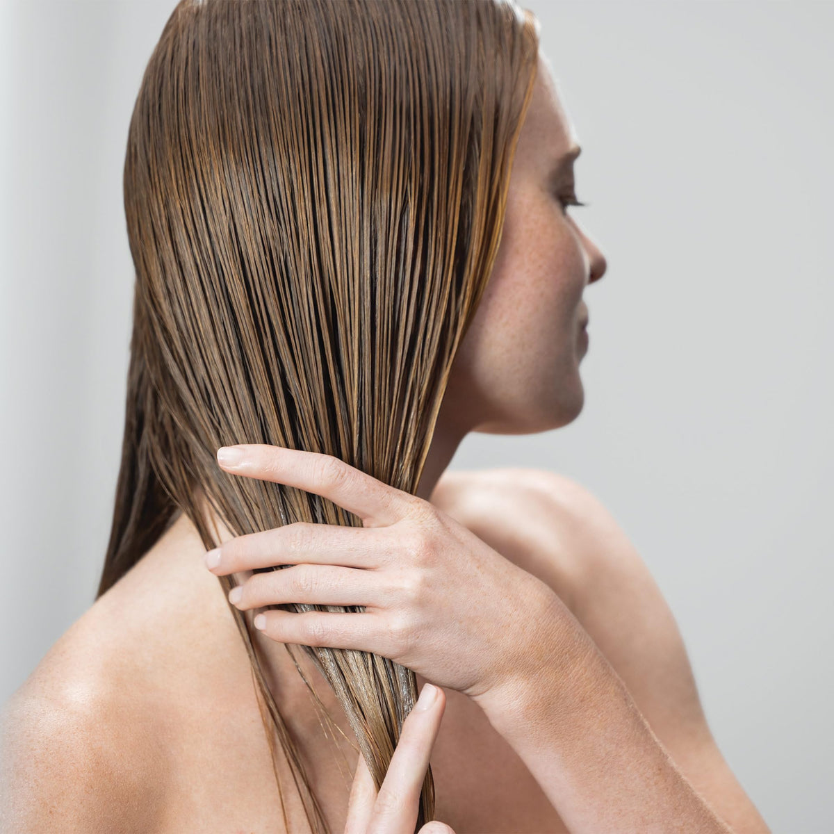 Hair section ready for blow-dry with Neuro Prime HeatCTRL primer.