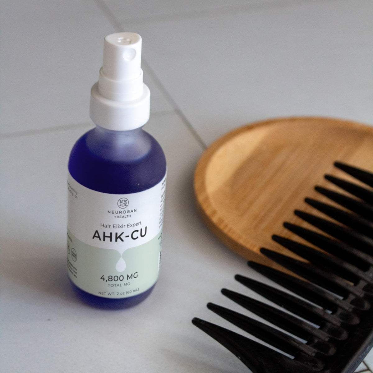 Neurogan AHK-Cu Hair Elixir morning routine spray on scalp.