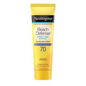 Neutrogena Beach Defense SPF 70 bottle on sunlit beach showing fast-absorbing protection