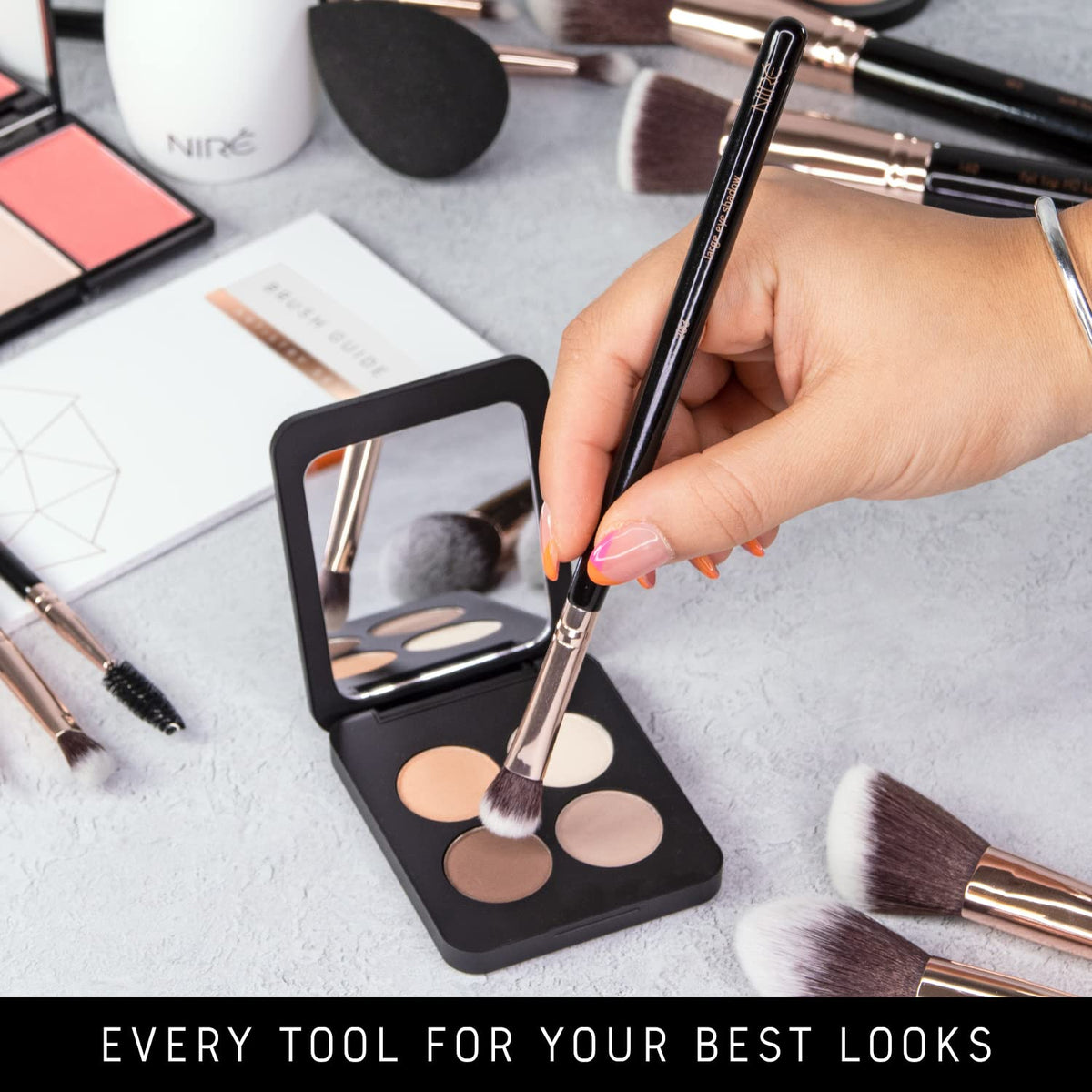Nire Beauty brushes in hand demonstrating control and precision.