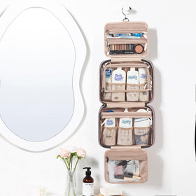 NISHEL Travel Toiletry Bag interior shows four sections for organized cosmetics