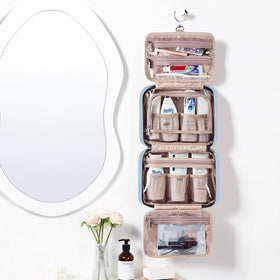 NISHEL bag interior shows four compartments for cosmetics and toiletries