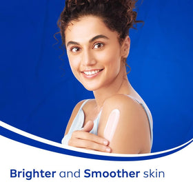 Applying NIVEA Natural Glow lotion on the arm to demonstrate texture