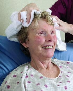 Traveler using No-Rinse CleanLife in travel bag for fresh hair