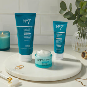 No7 Protect & Perfect application scene suggests balanced body care for firmer-feeling skin.