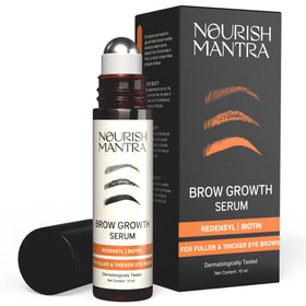 Nourish Mantra Eyebrow Growth Serum bottle on a vanity, suggesting fuller brows.