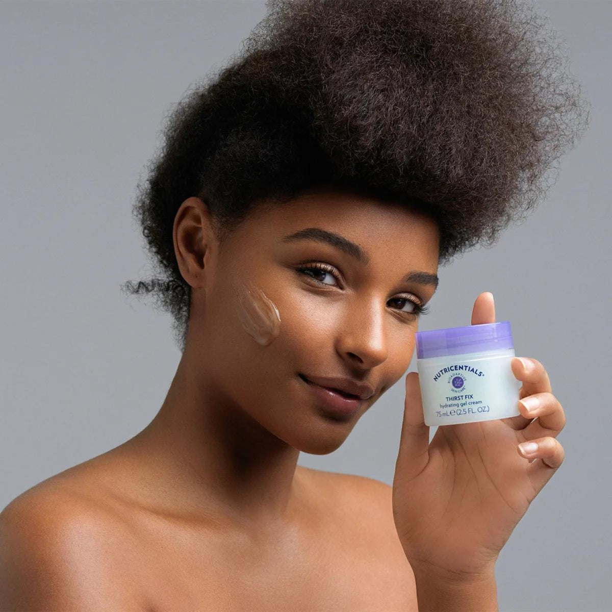 Nu Skin ThirstFix applied to cheek demonstrating cooling sensation.