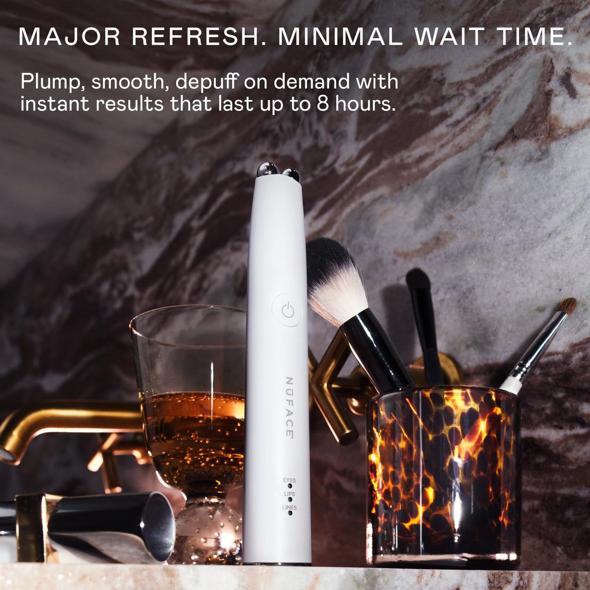 NuFACE FIX MicroWand in hand for portable use and control.