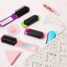 Nuogo travel brush shown in purse-friendly case for tidy on-the-go hair