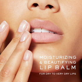 Close-up of applying Nuxe lip balm with rose oil for smooth lips.