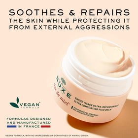 Hands applying Nuxe Reve de Miel balm to the face for comfort