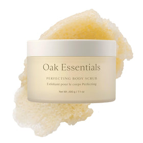 Oak Essentials Perfecting Body Scrub bottle on a bathroom shelf suggesting spa like hydration